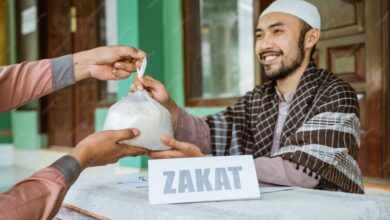 smiling young man giving bag rice mosque 1048944 23984440